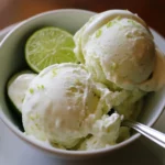 Lemon-lime ice cream with fresh lime slices in a white bowl, featuring creamy texture and citrus flavor. Perfect for summer desserts and refreshing treats, ideal for lemon-lime ice cream recipes.
