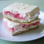 Delicious strawberry and cream layered dessert with graham cracker crust, topped with lime zest, perfect for summer recipes.