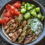 Juicy grilled chicken and fresh vegetable toppings in a Mediterranean-style chicken bowl.