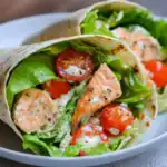 Fresh grilled chicken shawarma wrap with lettuce, cherry tomatoes, and creamy tahini sauce in a soft flatbread. Perfect for quick, flavorful meals with healthy ingredients.