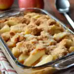 Creamy macaroni and cheese casserole with golden breadcrumbs topping, baked to perfection, served in a glass dish for easy family dinner or comfort food craving.