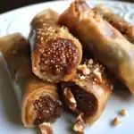 Creamy caramel and chocolate-filled spring rolls with chopped nuts, perfect for dessert or sweet snacks. A delicious treat inspired by Asian cuisine, ideal for special occasions or everyday indulgence.