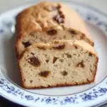 Butter cake, fruit-studded bread, delicious breakfast baking, homemade dessert, moist bread with dried fruits.
