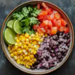 Fresh vegetable salsa with corn, black beans, diced tomatoes, red onion, cilantro, and lime, perfect for healthy meal recipes or as a vibrant appetizer.