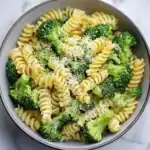 Creamy broccoli pasta in a bowl topped with grated Parmesan cheese, perfect for a quick and healthy meal. Ideal for pasta lovers seeking delicious vegetarian dinner ideas.