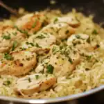 Juicy, perfectly seasoned chicken breasts served over flavorful rice, garnished with fresh herbs, ideal for easy weeknight dinner or meal prep.