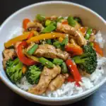 Stir-fry chicken with colorful vegetables served over rice, healthy and delicious Asian-inspired dinner or lunch option.
