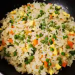 Stir-fried rice with vegetables and scrambled eggs, a quick and easy homemade dish perfect for weeknight dinners and meal prep. Delicious, savory, and nutritious.