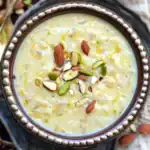 Creamy Indian rice pudding, Kheer, garnished with mixed nuts like almonds, cashews, and pistachios, served in a traditional bowl. Perfect dessert for festivals and celebrations.
