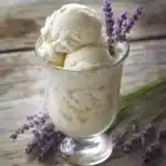 Creamy vanilla ice cream in a glass with lavender sprigs, perfect for a refreshing summer treat or dessert. Made with natural ingredients for a delicious homemade ice cream experience.