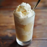 1. Creamy vanilla ice cream float in a tall glass with a straw, served on a rustic wooden table.