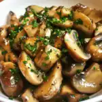 Sauteed garlic mushrooms garnished with fresh parsley, a delicious and savory side dish perfect for any meal, easy to prepare with fresh mushrooms and flavorful seasonings.