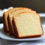 Fluffy vanilla sponge cake slices on a white plate, perfect for dessert or tea time.