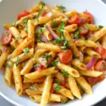 Creamy pasta with cherry tomatoes, red onions, and fresh herbs - perfect for quick and delicious weeknight dinners.