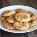 Soft homemade cinnamon snickerdoodle cookies on a white plate, dusted with cinnamon sugar, perfect for dessert or snack.