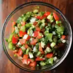 Freshly diced tomatoes, onions, celery, and cilantro in a glass bowl, perfect for homemade salsa or salads. Vegan, healthy, quick, easy to prepare, fresh ingredients, vegetarian, low-calorie, and delicious.