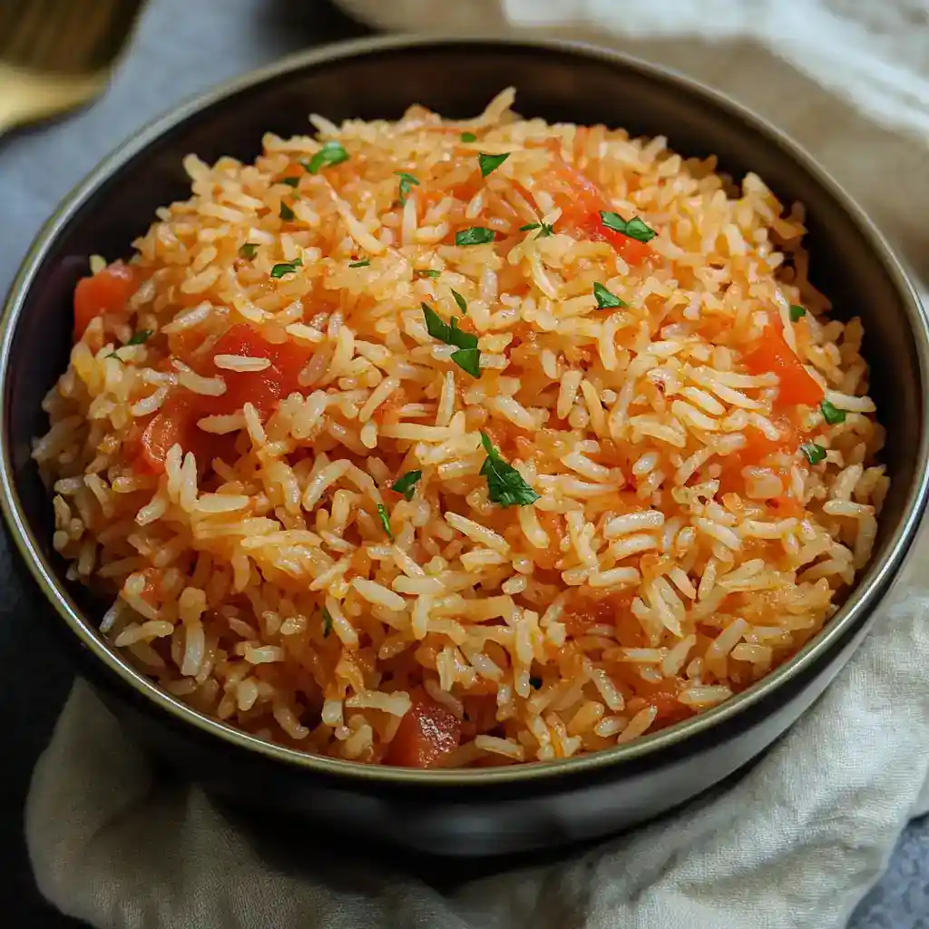 Creamy tomato rice with fresh herbs, perfect for quick weeknight dinners and meal prep. Fluffy rice cooked in flavorful tomato sauce, garnished with chopped parsley for a vibrant touch.