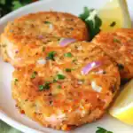 Delicious golden-brown crab cakes with fresh herbs served with lemon wedges, perfect for seafood lovers and easy to make at home.
