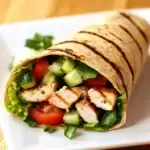 Fresh chicken wrap with grilled chicken, crisp vegetables, and flavorful herbs, wrapped in a soft tortilla. Perfect for a healthy lunch or quick dinner option.