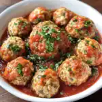 Delicious homemade meatballs in rich marinara sauce, topped with fresh herbs. Perfect for pasta, parties, or a hearty dinner. Easy to make with fresh ingredients for a flavorful meal.