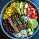 Fresh Mexican-inspired beef bowl with rice, black beans, corn, avocado, tomato salsa, and lime, perfect for healthy meal prep, easy dinner, or lunch. Packed with flavors and nutritious ingredients.
