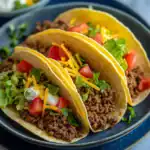 Delicious beef tacos loaded with fresh vegetables, cheese, and sour cream, perfect for any meal or family dinner. Easy to prepare and full of flavor.
