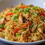 Quick noodle stir-fry with chicken, vegetables, and soy sauce, perfect for a delicious and easy Asian-inspired meal.