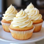 Delicious vanilla cupcakes topped with smooth, creamy swirl frosting, perfect for celebrations or sweet treats. Easy to make with simple ingredients for a delightful dessert.