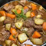 Hearty beef stew with tender beef chunks, carrots, potatoes, and onions in a savory broth, perfect for comforting meals.