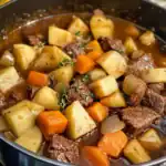 Delicious beef stew with potatoes, carrots, and onions in a savory broth, perfect for comforting meals and family dinners.