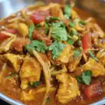 Delicious chicken tikka masala with tender chicken pieces, tomatoes, and fresh cilantro in a rich, flavorful curry sauce. Perfect for Indian cuisine lovers.