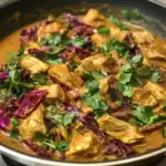 Delicious chicken and cabbage stir-fry with flavorful sauce, garnished with fresh cilantro, perfect for quick and healthy meals.