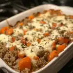 An inviting baked lentil casserole with tender carrots, melted cheese, and herbs, perfect for a nutritious and comforting meal.